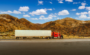 a truck is parked on the side of a mountain road